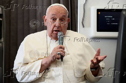 FILE PHOTO: Pope Francis holds a news conference aboard the papal plane