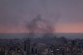 Smoke rises in Beirut's southern suburbs during sunset, after Israeli air strikes, amid ongoing hostilities between Hezbollah and Israeli forces, as seen from Sin El Fil