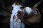 Palestinians mourn their dead following Israeli airstrike on Al-Mawasi