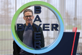 Bill Anderson, CEO of Germany's drug maker Bayer AG poses for a portrait session next to the company?s logo at the Bayer headquarters in Leverkusen