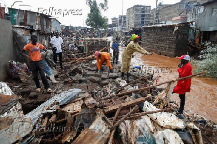 Residents recover their belongings after the Nairobi river burst its banks in the Mathare Valley settlement in Nairobi