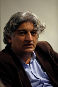 FILE PHOTO: Matiullah Jan, a journalist and columnist, reacts during an interview with Reuters at his office in Islamabad,