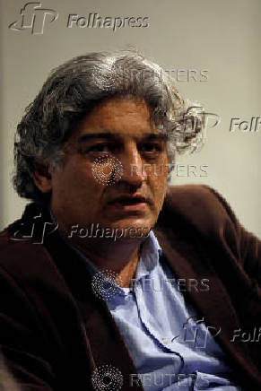 FILE PHOTO: Matiullah Jan, a journalist and columnist, reacts during an interview with Reuters at his office in Islamabad,