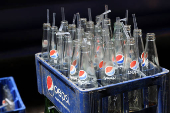 Crate full of empty bottles of Pepsi placed outside a cafe to be picked by supply truck in Karachi