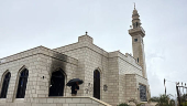 Palestinians check damage to a mosque burned by Israeli settlers in the West Bank