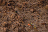 Rescue personnel carry the body of an agent of the National Institute of Migration (INM), in Ciudad Juarez