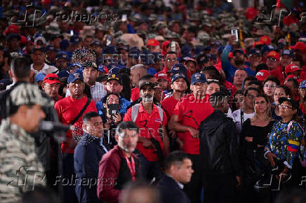 Members of the Bolivarian Militia and supporters of President Nicolas Maduro march to plead allegiance