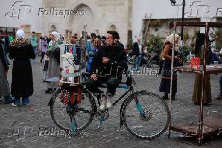 People walk at a traditional souq in the Bab Touma district of the Old City of Damascus