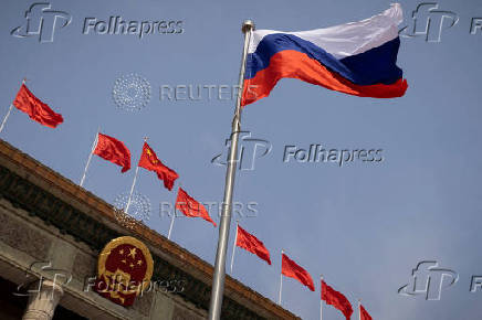 FILE PHOTO: The Russian flag flies in front of the Great Hall of the People before a welcoming ceremony for Russian Prime Minister Mikhail Mishustin in Beijing