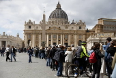 Tourists queue to visit St. Peter's Basilica