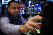 Traders work on the floor of the NYSE in New York