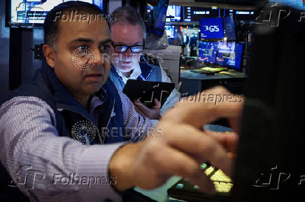 Traders work on the floor of the NYSE in New York