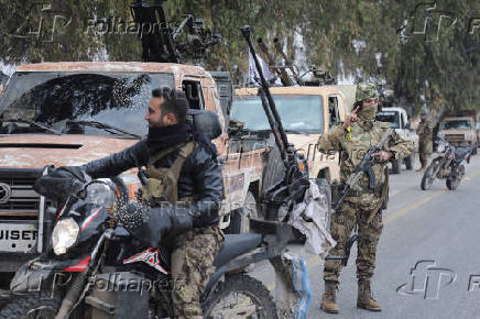 A rebel fighter gestures in Homs countryside