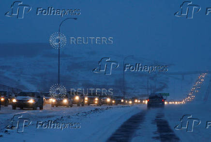 FILE PHOTO: Afternoon commuter traffic is at a standstill on a Calgary street as a major winter snowstorm hit Western Canada in Calgary