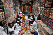 Muslims pray before they eat their Iftar (breaking of fast) meal at a shop during the fasting month of Ramadan in the old quarters of Delhi
