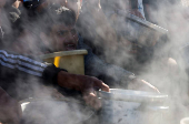 Palestinians gather to receive food cooked by a charity kitchen, amid a hunger crisis, in Khan Younis