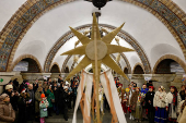 People dressed in traditional clothes sing carols inside a metro in Kyiv