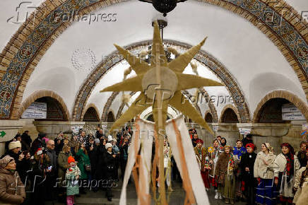 People dressed in traditional clothes sing carols inside a metro in Kyiv