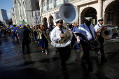 Members of the Perfect Gentlemen Social and Pleasure Club lead a second line parade in New Orleans