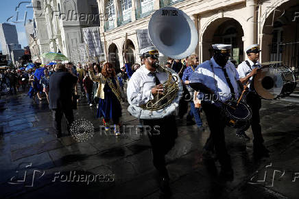 Members of the Perfect Gentlemen Social and Pleasure Club lead a second line parade in New Orleans