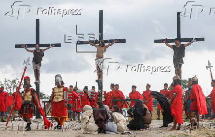 Catholic penitent nailed to cross on Good Friday in Holy Week of Lent