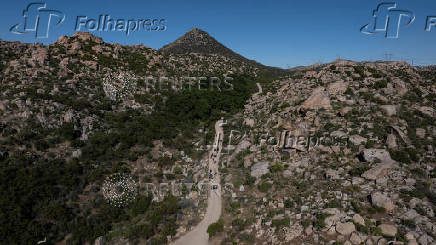 Asylum seeking migrants from China climb hill in Jacumba Hot Springs, California