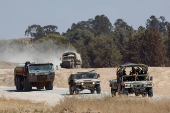 An Israeli military convoy maneuvers near the Israel-Gaza border