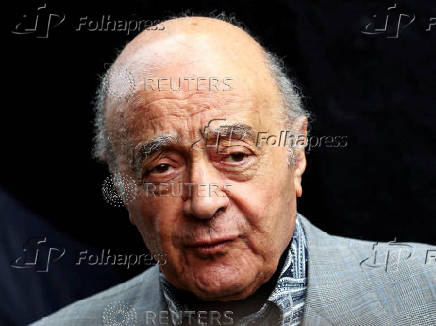 FILE PHOTO: Fulham's chairman Mohamed Al Fayed listens as Fulham's new manager Mark Hughes speaks during a news conference at Craven Cottage stadium in London