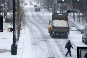 FILE PHOTO: Salt truck drives downtown during a snow storm in Cincinnati