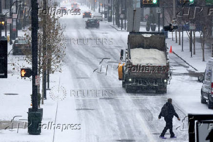 FILE PHOTO: Salt truck drives downtown during a snow storm in Cincinnati