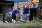 Police officers inspect objects removed from the boat in which decomposed bodies were found by fishermen, at the Para Scientific Police headquarters in Braganca