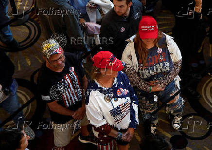 Supporters wait in line to see Republican vice presidential nominee JD Vance and Robert F. Kennedy Jr. take part in a moderated discussion with actor Zachary Levi in Dearborn