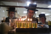 Ultra Orthodox Jews light Hanukkah holiday candles in Jerusalem