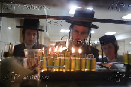 Ultra Orthodox Jews light Hanukkah holiday candles in Jerusalem