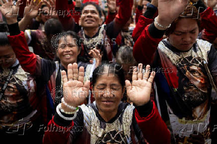 Filipino Catholics participate in the parade of Black Nazarene replicas