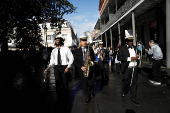 Members of the Perfect Gentlemen Social and Pleasure Club lead a second line parade in New Orleans