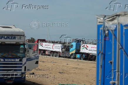 Aid trucks wait near the Rafah border crossing between Egypt and the Gaza Strip