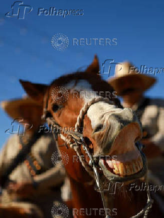 People take part in a parade marking the 114th anniversary of the Mexican Revolution, in Ciudad Juarez