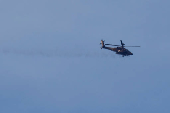 An Apache helicopter fires towards the northern Gaza Strip as seen from the Israel side of the border, near Sderot