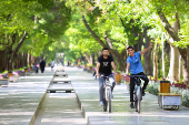 Iranian men ride bicycles, after a reported Israeli attack on Iran, in Isfahan Province