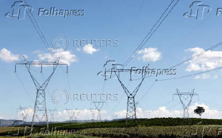 FILE PHOTO: Electricity transmission towers stand over a coffee farm in Santo Antonio do Jardim