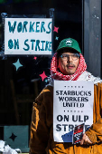 Workers picket in front of a Starbucks in the Brooklyn borough in New York