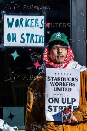 Workers picket in front of a Starbucks in the Brooklyn borough in New York