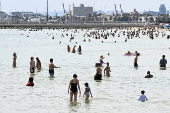 Beachgoers enjoy St Kilda beach