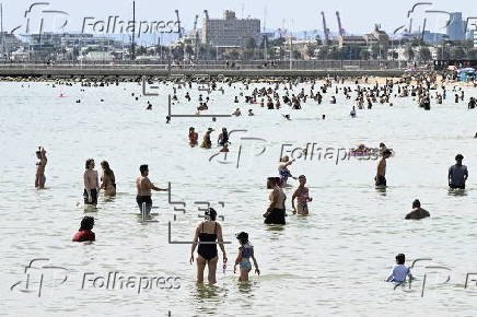 Beachgoers enjoy St Kilda beach