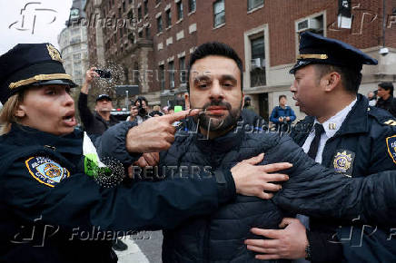 An Israeli Arab is escorted by police after an incident with pro-Palestinian protesters during a protest in solidarity with Pro-Palestinian organizers on the Columbia University campus, in New York City