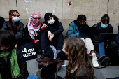 Masked youths take part in a protest in support of Palestinians in Gaza, in Paris