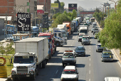 Vehicles wait in line to refuel with diesel, in Cochabamba