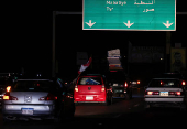 Vehicles drive south south from Zahrani, after a ceasefire between Israel and Iran-backed group Hezbollah took effect