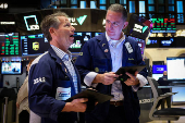 Traders work on the floor of the NYSE in New York